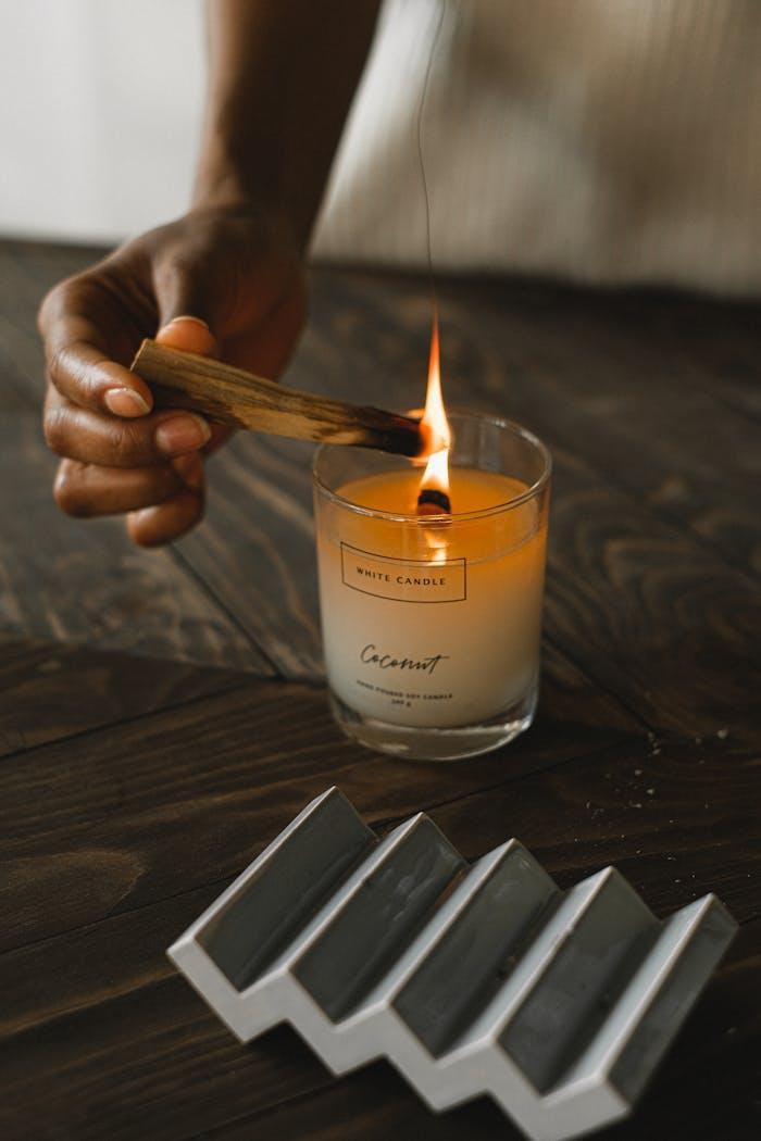 Mastering the First Impression: Your intriguing post title goes here A calming scene with a hand lighting a coconut-scented candle using palo santo.